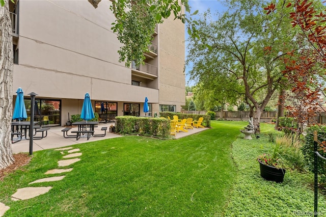 view of yard featuring a balcony and a patio area