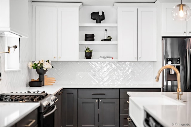 kitchen with a sink, open shelves, white cabinetry, and stainless steel appliances