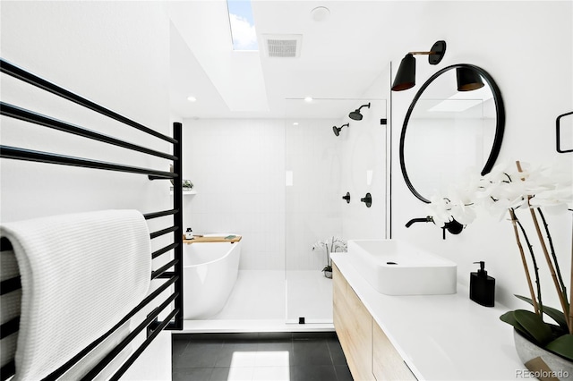 bathroom featuring visible vents, double vanity, a sink, tile patterned flooring, and a shower stall