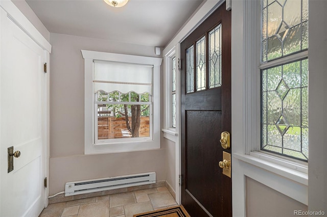 726 S Corona St, Denver, CO 80209 - foyer entrance featuring a baseboard heating unit, stone finish floors, and baseboards