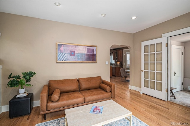 726 S Corona St, Denver, CO 80209 - living area featuring arched walkways, light wood finished floors, baseboards, and recessed lighting