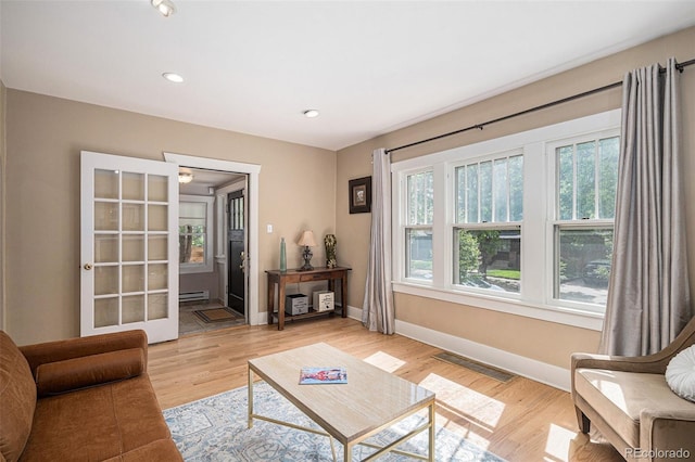 726 S Corona St, Denver, CO 80209 - living room with a baseboard heating unit, baseboards, light wood-style floors, and recessed lighting
