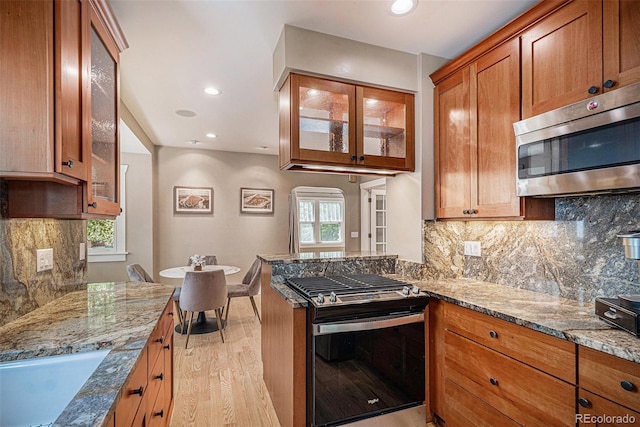 726 S Corona St, Denver, CO 80209 - kitchen featuring range with gas cooktop, stainless steel microwave, light wood-type flooring, stone countertops, and recessed lighting