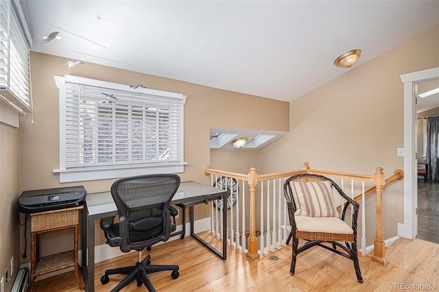 726 S Corona St, Denver, CO 80209 - home office featuring wood finished floors, baseboard heating, and baseboards