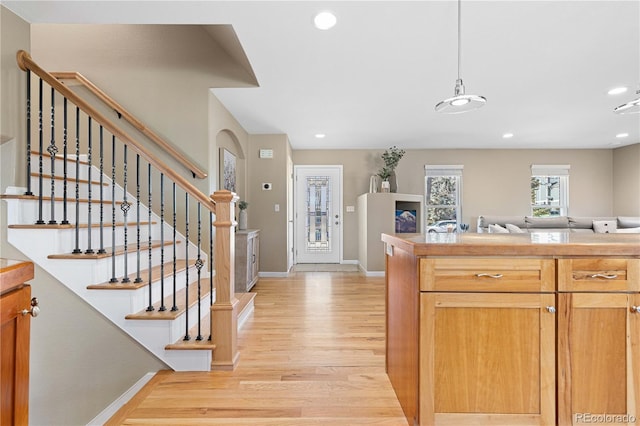 kitchen featuring recessed lighting, light wood-style floors, open floor plan, and baseboards