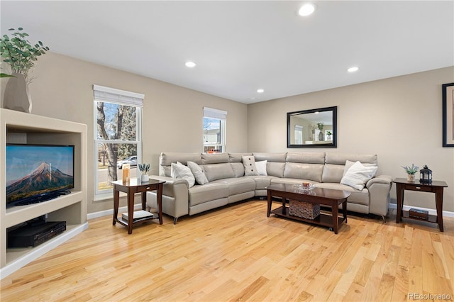 living area featuring recessed lighting, wood finished floors, and baseboards