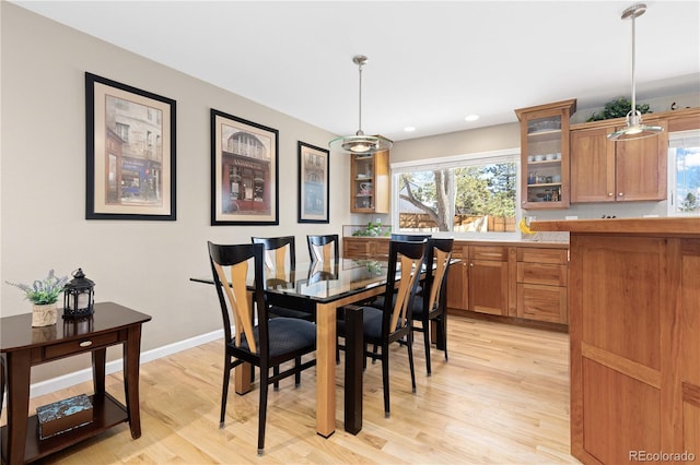 dining area featuring recessed lighting, baseboards, and light wood-style floors