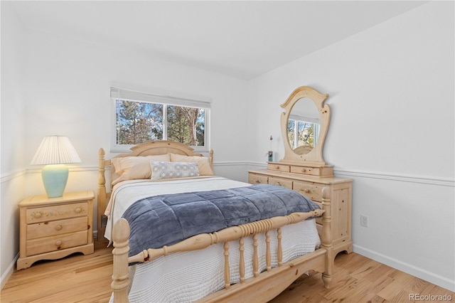 bedroom featuring baseboards and light wood-style floors