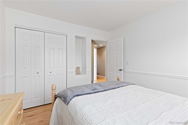 bedroom with light wood-style floors and a closet