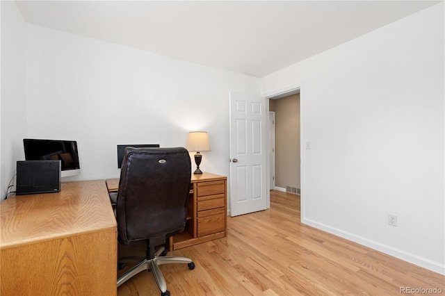 office featuring light wood-type flooring, baseboards, and visible vents