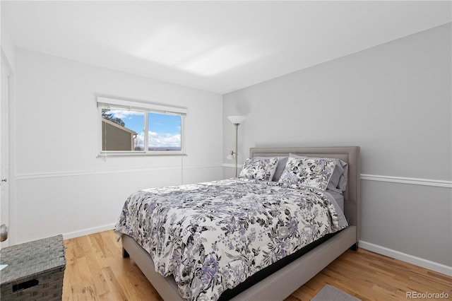 bedroom featuring baseboards and wood finished floors