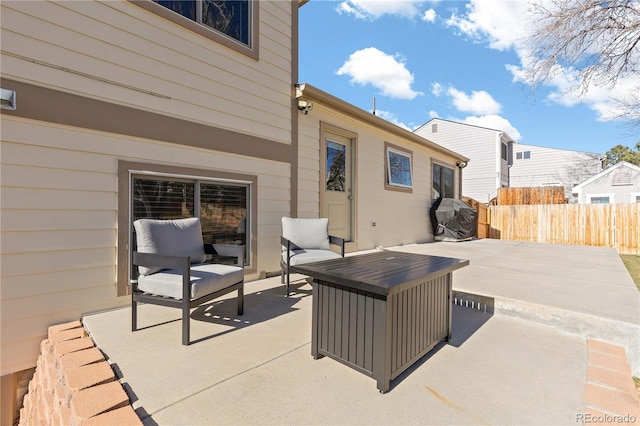 view of patio / terrace with a grill and fence