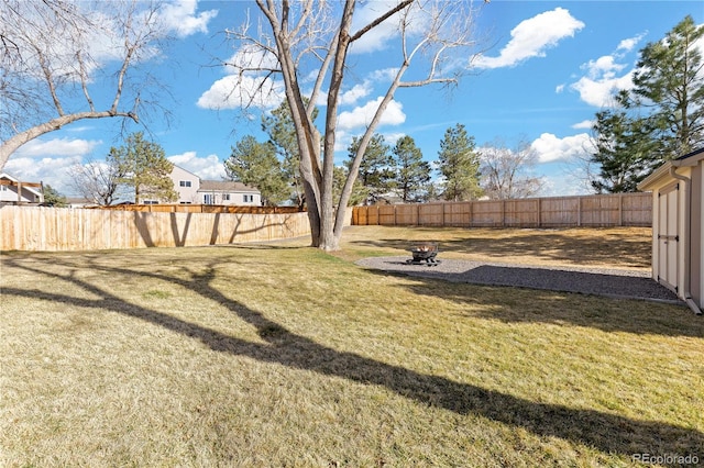 view of yard featuring a fire pit and a fenced backyard