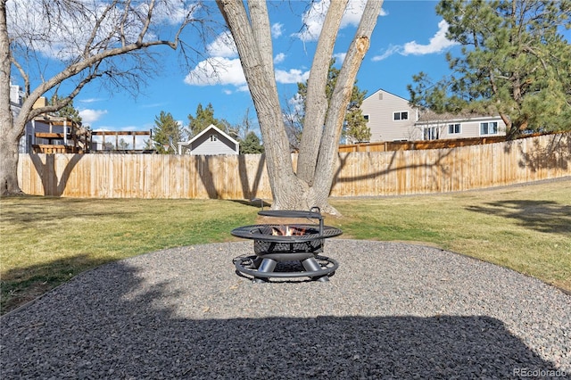 view of yard featuring a patio area, a fire pit, and fence