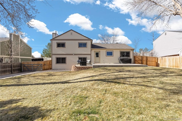 back of house with a yard, a patio, a fenced backyard, and a gate