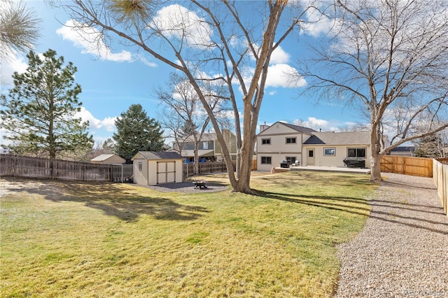 view of yard with a fenced backyard, a patio area, a storage unit, and an outdoor structure