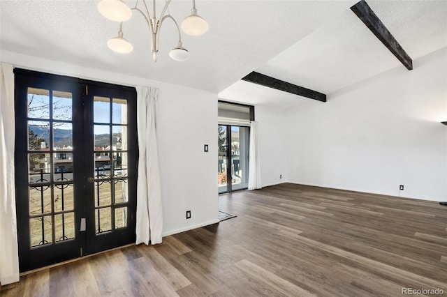 interior space featuring beamed ceiling, a textured ceiling, dark wood-type flooring, and french doors