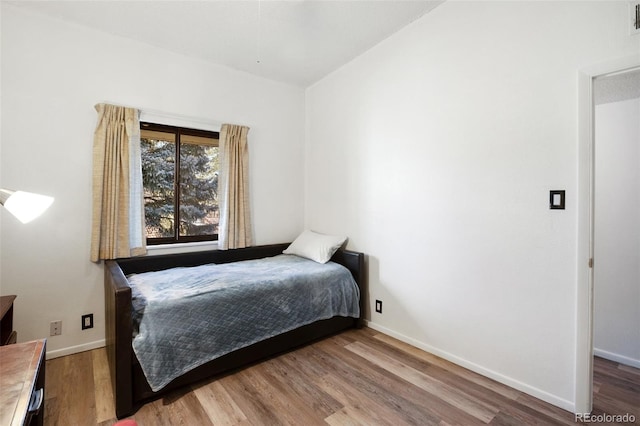 bedroom with wood-type flooring