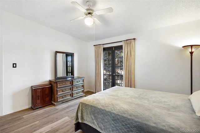 bedroom featuring a textured ceiling, light hardwood / wood-style flooring, and ceiling fan