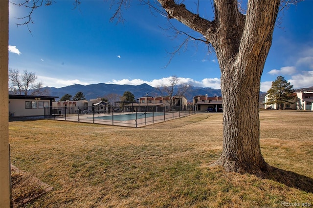 view of yard with a fenced in pool and a mountain view