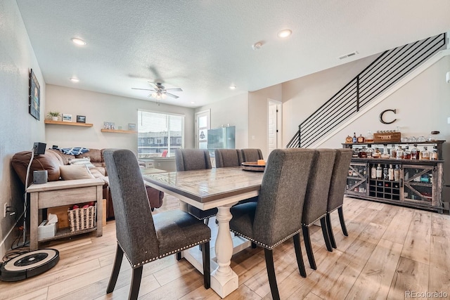 16433 Askins Loop, Parker, CO 80134 - dining space featuring ceiling fan, light wood-type flooring, stairway, a textured ceiling, and recessed lighting