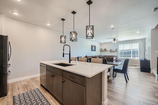 16433 Askins Loop, Parker, CO 80134 - kitchen featuring a sink, dishwasher, freestanding refrigerator, light wood-type flooring, and a ceiling fan