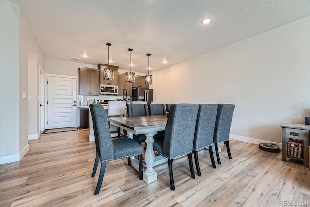 16433 Askins Loop, Parker, CO 80134 - dining area featuring light wood finished floors, baseboards, and recessed lighting