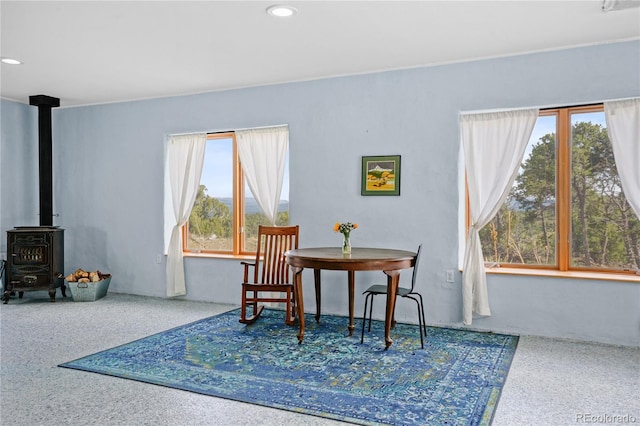 dining space featuring a wood stove and recessed lighting