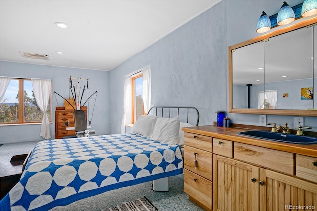 bedroom featuring recessed lighting and a sink