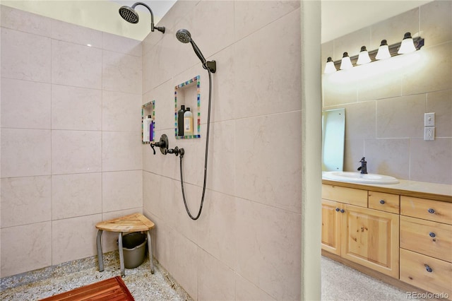 full bath featuring vanity, decorative backsplash, tile walls, and tiled shower