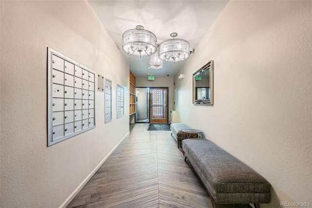 hallway with wood-type flooring and a mail area