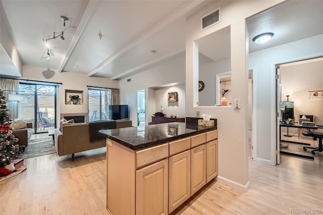 kitchen with kitchen peninsula, light hardwood / wood-style flooring, and track lighting