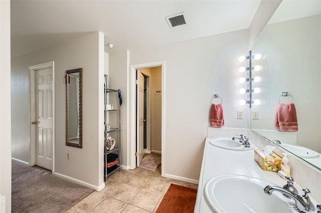 bathroom with tile patterned flooring and vanity