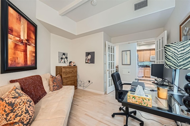 office featuring french doors, light hardwood / wood-style floors, and beam ceiling