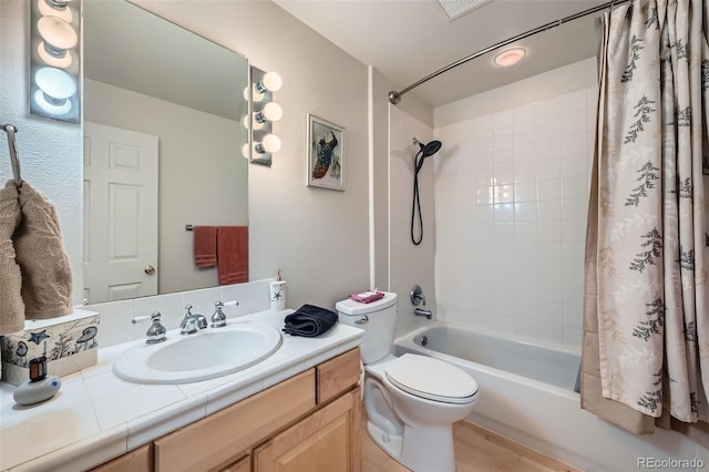 full bathroom featuring vanity, toilet, and shower / bathtub combination with curtain