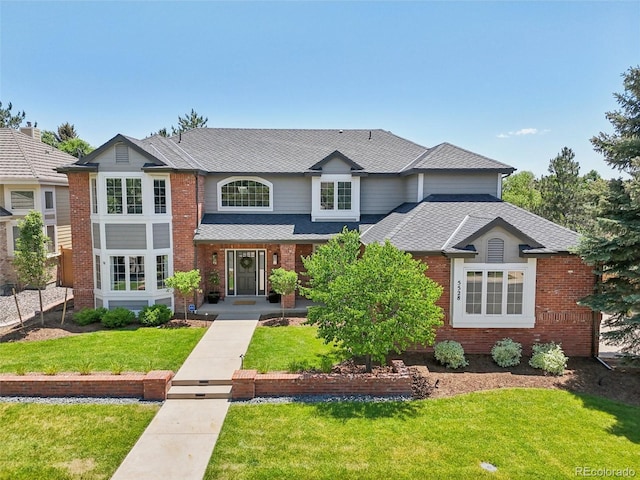 5528 S Jasper Way, Centennial, CO 80015 - traditional home with a front yard, brick siding, and a shingled roof