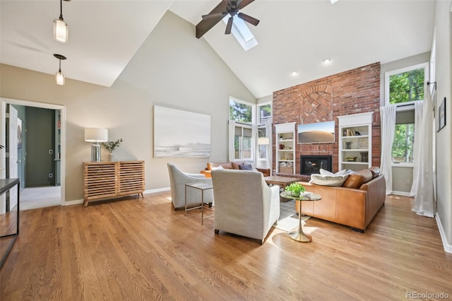 5528 S Jasper Way, Centennial, CO 80015 - living room with high vaulted ceiling, ceiling fan, wood finished floors, a skylight, and a fireplace