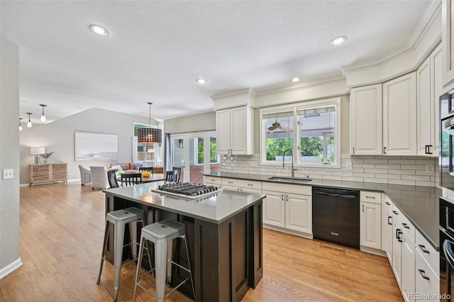 5528 S Jasper Way, Centennial, CO 80015 - kitchen with dishwasher, stainless steel gas stovetop, backsplash, a kitchen breakfast bar, and plenty of natural light