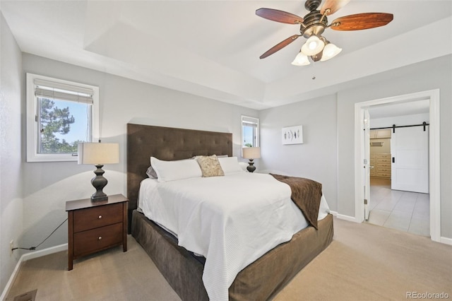 5528 S Jasper Way, Centennial, CO 80015 - bedroom featuring a raised ceiling, carpet, multiple windows, and a barn door