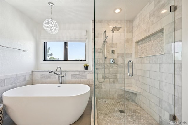 5528 S Jasper Way, Centennial, CO 80015 - bathroom with a stall shower, a freestanding tub, and tile walls