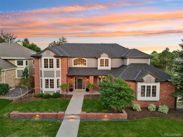 5528 S Jasper Way, Centennial, CO 80015 - traditional-style house featuring brick siding, a lawn, and a shingled roof