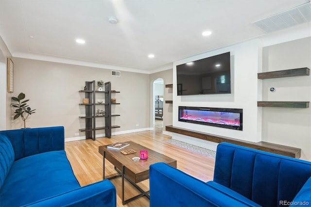 2664 Forest St, Denver, CO 80207 - living room featuring arched walkways, wood finished floors, baseboards, recessed lighting, and ornamental molding