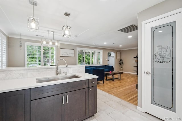 2664 Forest St, Denver, CO 80207 - kitchen featuring a sink, light countertops, pendant lighting, recessed lighting, and ornamental molding