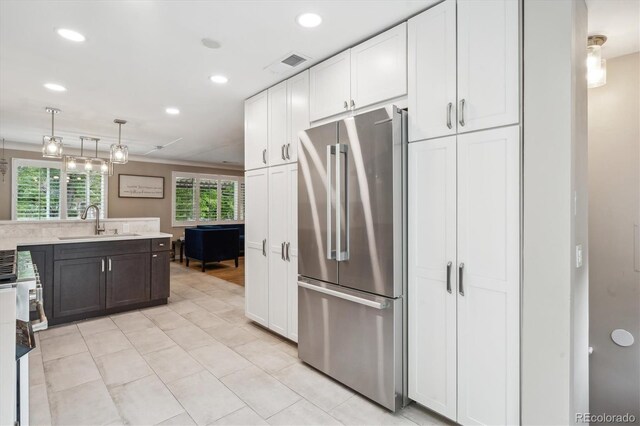 2664 Forest St, Denver, CO 80207 - kitchen with appliances with stainless steel finishes, a sink, recessed lighting, white cabinets, and light countertops