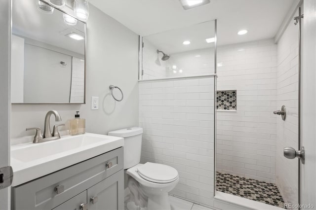 2664 Forest St, Denver, CO 80207 - bathroom with a tile shower, toilet, vanity, and recessed lighting