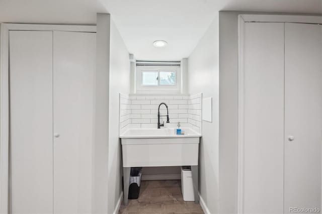 2664 Forest St, Denver, CO 80207 - bathroom featuring baseboards, wood finished floors, and backsplash