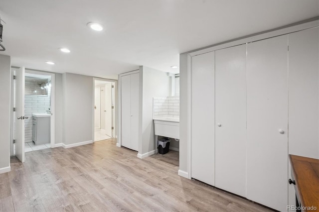 2664 Forest St, Denver, CO 80207 - unfurnished bedroom with light wood finished floors, recessed lighting, connected bathroom, and baseboards