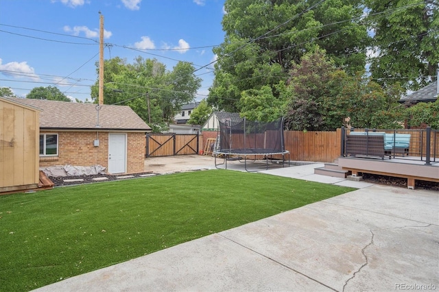 2664 Forest St, Denver, CO 80207 - view of yard featuring a trampoline, a patio area, a wooden deck, and a gate