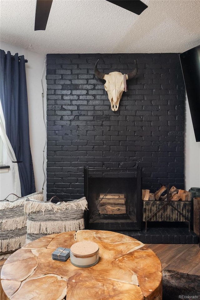 2700 S Holly St Unit 202, Denver, CO 80222 - detailed view of wood finished floors, a textured ceiling, and a brick fireplace