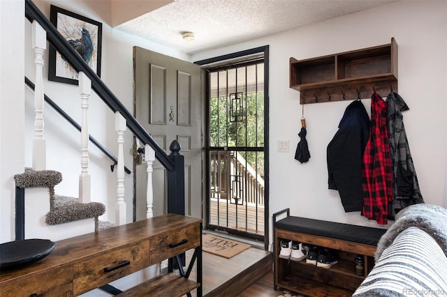 2700 S Holly St Unit 202, Denver, CO 80222 - mudroom featuring wood finished floors and a textured ceiling